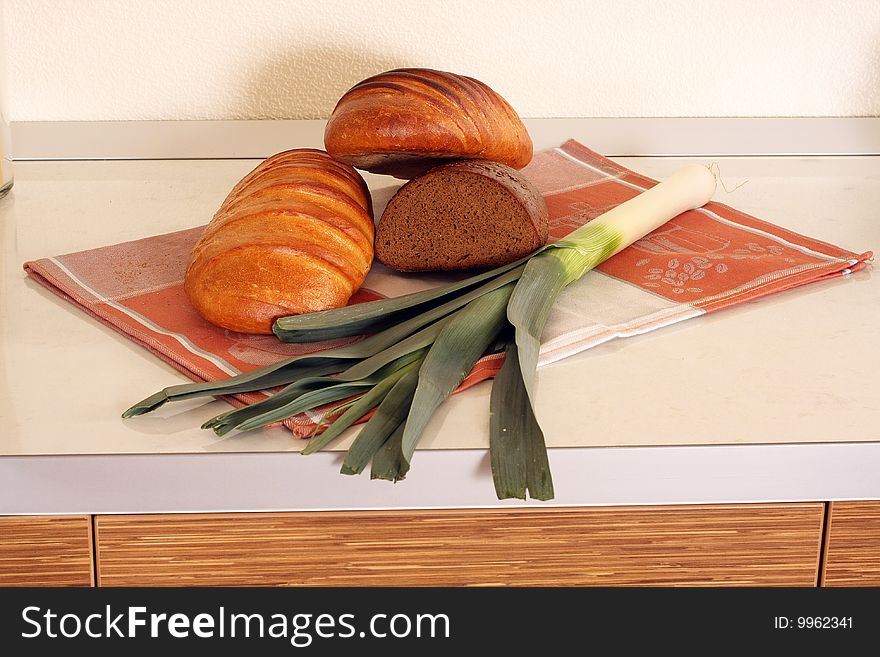 Bread on kitchen table wth salad
