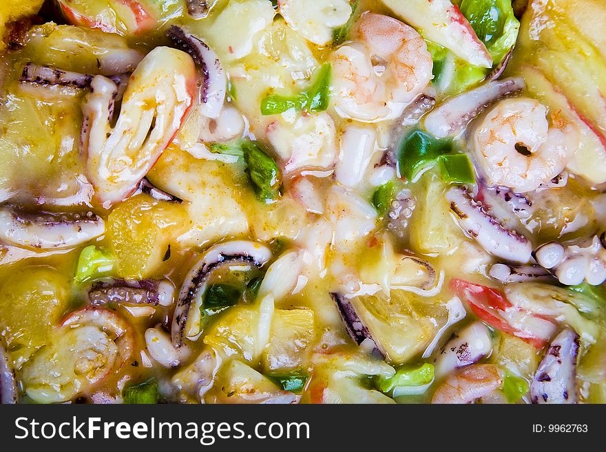 A close up of a seafood pizza.