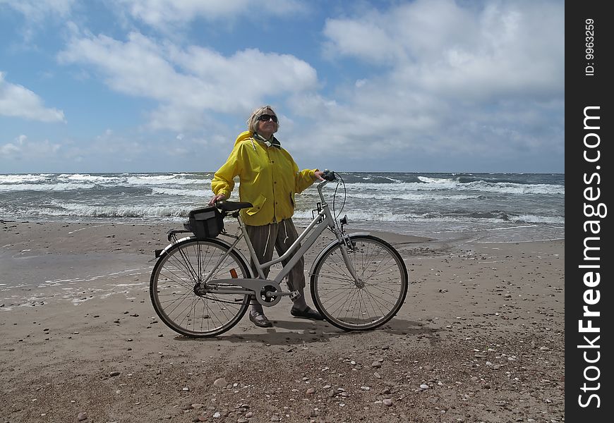 Senior woman with bicycle on sea shore. Senior woman with bicycle on sea shore