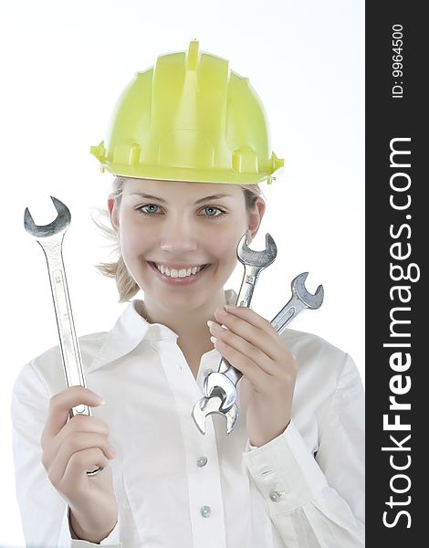 Pretty girl with helmet and wrench over white background