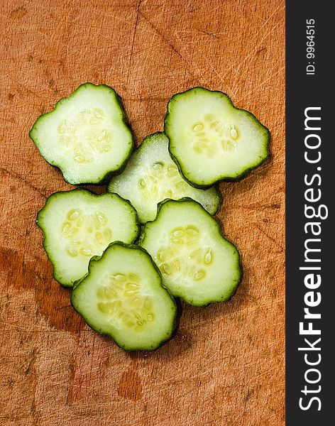 Close up cucumber slices isolated on wood table