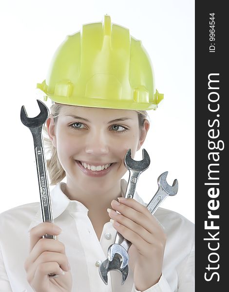 Pretty girl with helmet and wrench over white background