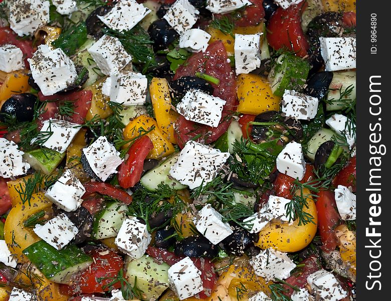 A close-up of a rustic Greek salad with feta cheese. A close-up of a rustic Greek salad with feta cheese