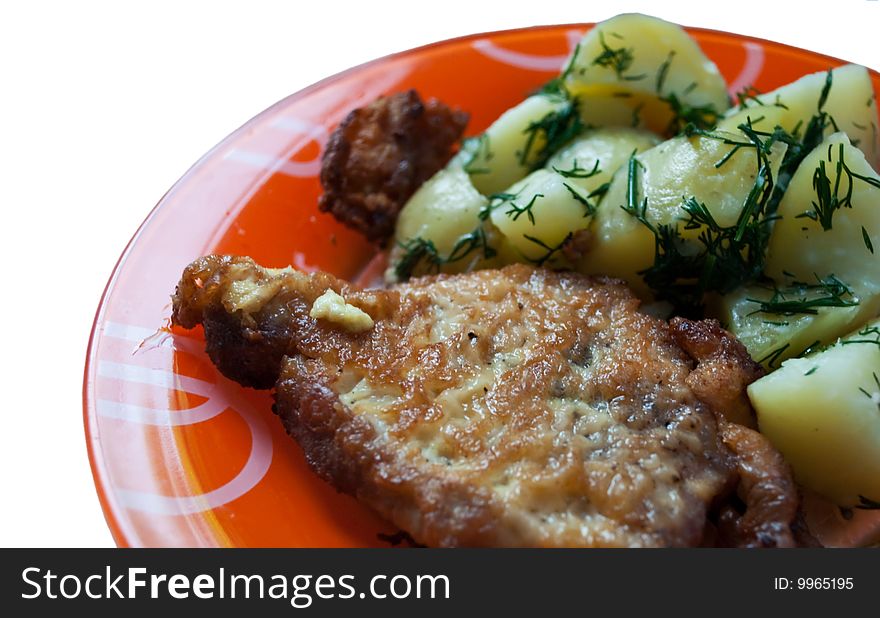 Cutlet with potatoes and dill on the orange dish. Cutlet with potatoes and dill on the orange dish