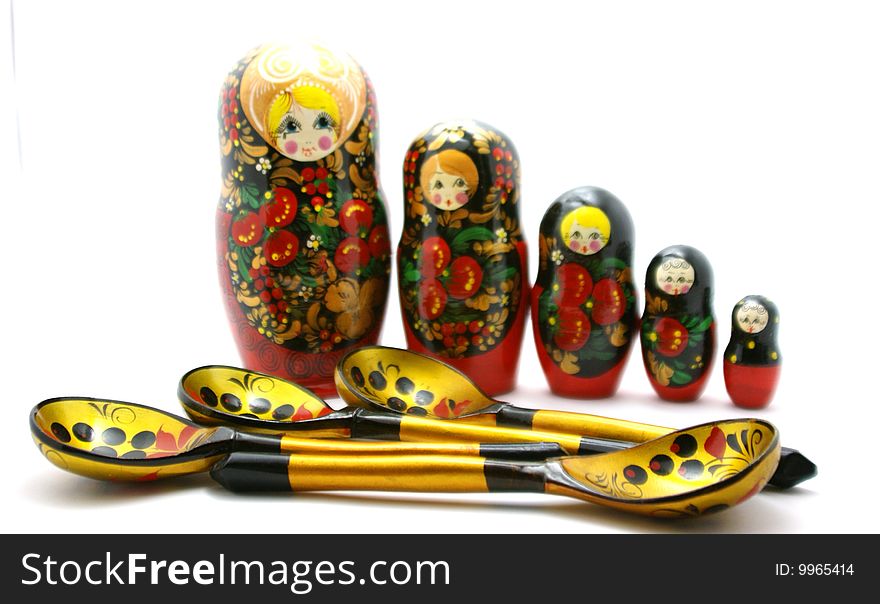 Matryoshka and spoons on a white background, close-up removed