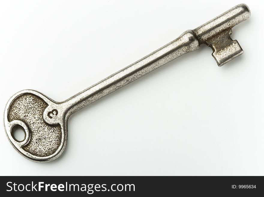 Isolated closeup of old shiny key. Isolated closeup of old shiny key