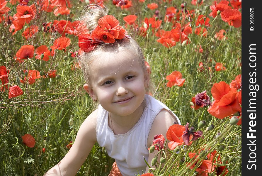 On the image there is a little girl. She is in poppys. On the image there is a little girl. She is in poppys.