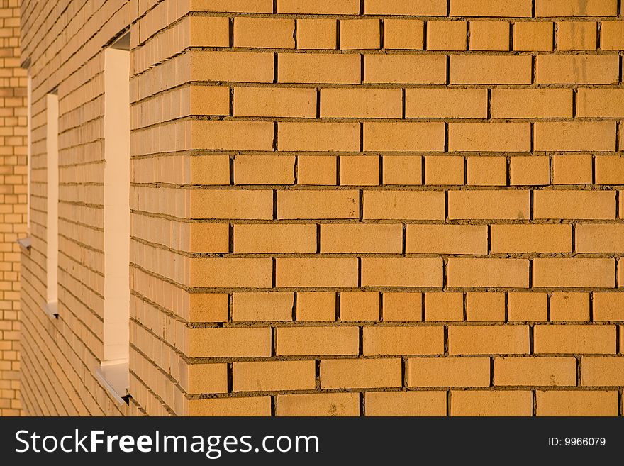 Yellow brick wall in sunset light as it is