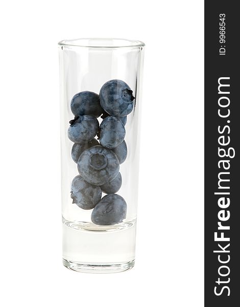 Huckleberries in glass, isolated on white background