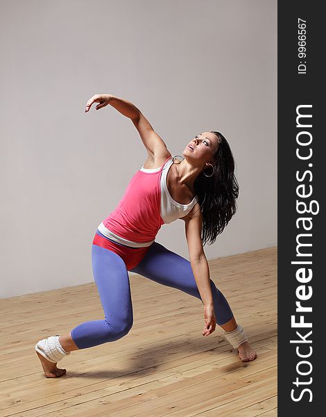 Modern style dancer posing on studio background. Modern style dancer posing on studio background