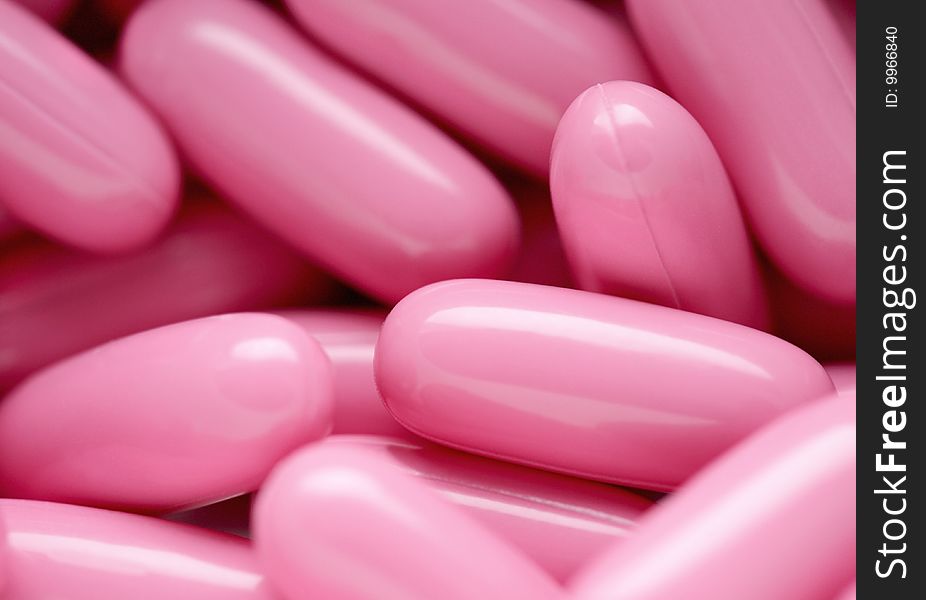 The group of pink capsules helping the healthy lifestyle