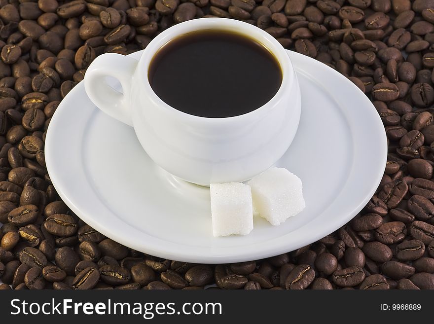 Cup of black coffee on coffee beans background. Cup of black coffee on coffee beans background