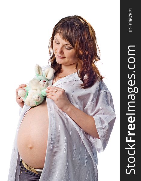 Pregnant woman on the isolated background with rabbit toy in her hands. Pregnant woman on the isolated background with rabbit toy in her hands