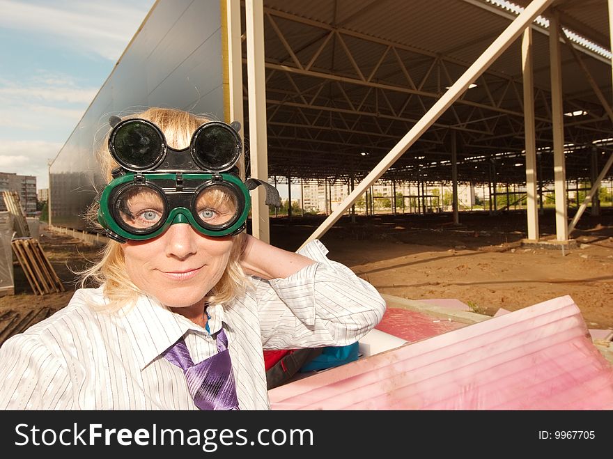 Portrait of engineer in protective glasses on construction site