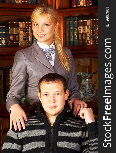 Young couple posing in the library-room