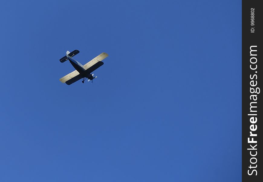 Biplane isolated on the blue sky