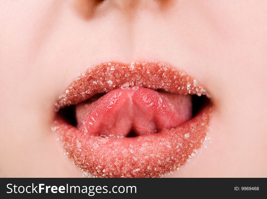 Woman licking spilled sugar from her lips. Woman licking spilled sugar from her lips