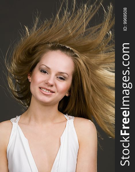 Happy young girl with long flying hair