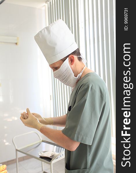 Medical theme: a surgeon in operative room. Medical theme: a surgeon in operative room.