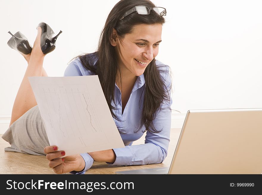 Female professional sitting in casual position with laptop. Female professional sitting in casual position with laptop