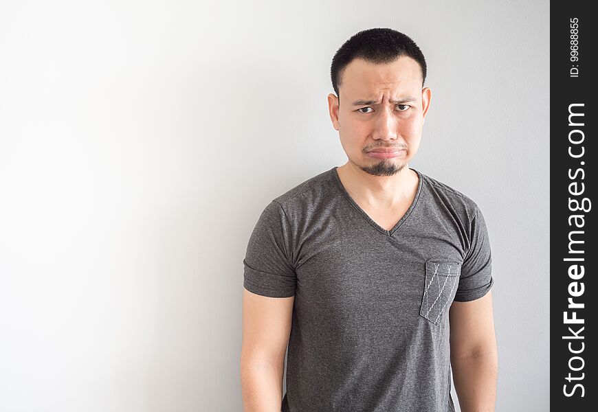 Sad And Scared Asian Man In Black T-shirt.