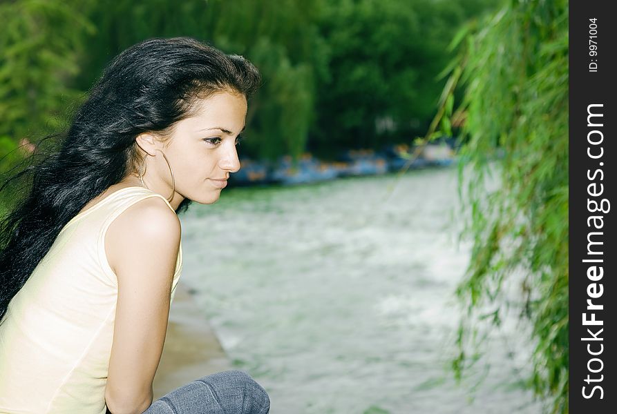 Pretty girl sitting by the lake. Pretty girl sitting by the lake