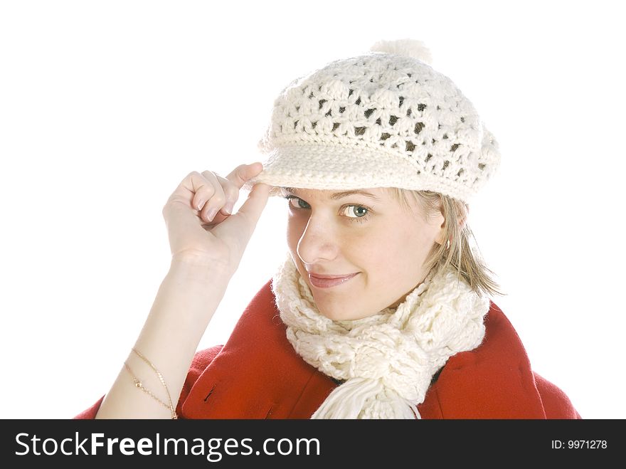 Young woman in a winter cap looking coquettishly isolated over white. Young woman in a winter cap looking coquettishly isolated over white