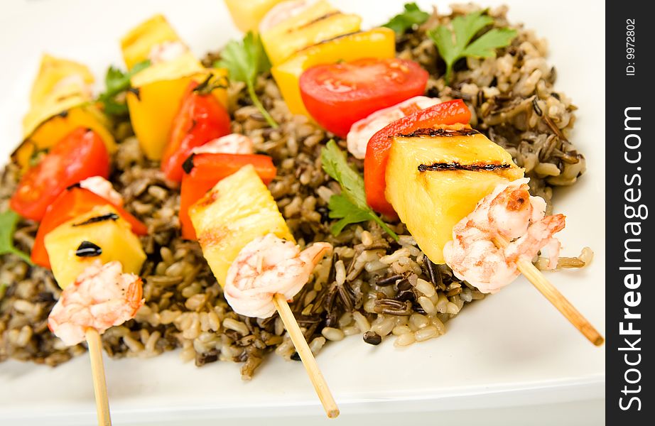 Shrimp on Bamboo skewers served on a bed of wild rice. Shrimp on Bamboo skewers served on a bed of wild rice