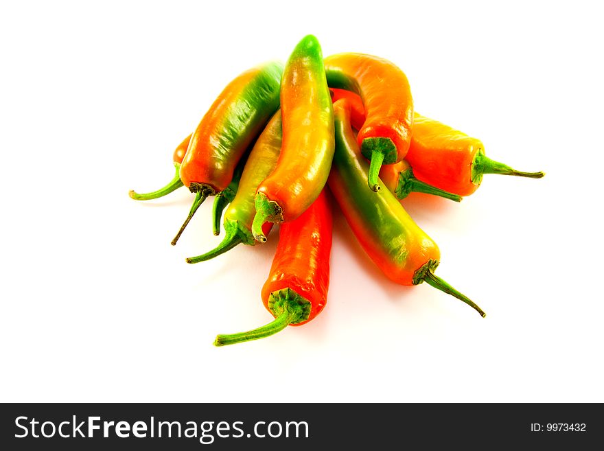 Pile of red and green chillis with clipping path on a white background. Pile of red and green chillis with clipping path on a white background