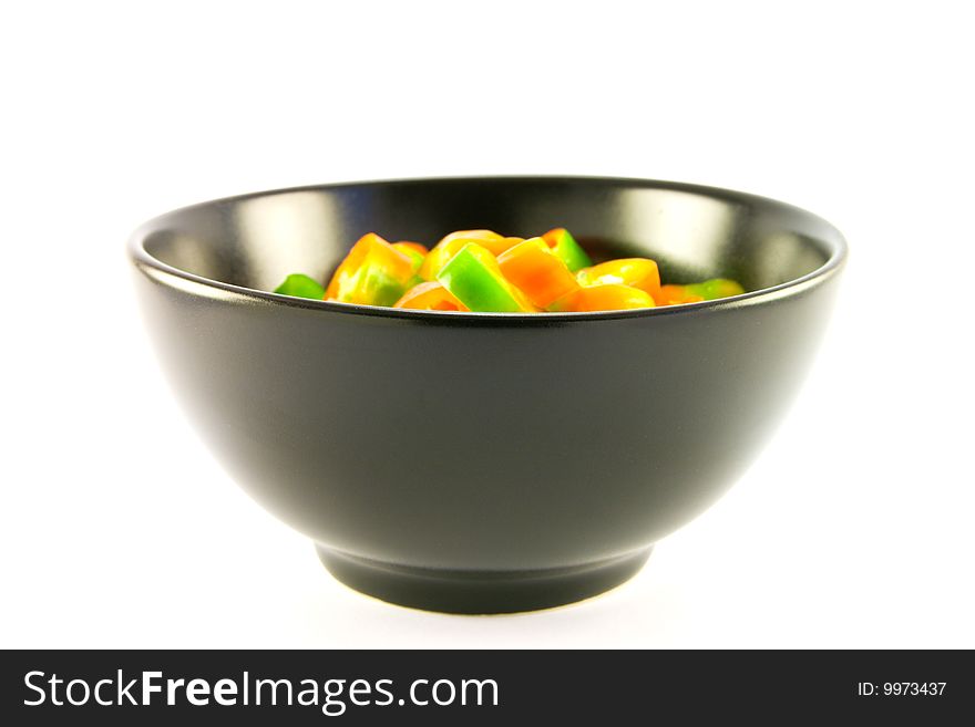 Chopped chillis in a black bowl with clipping path on a white background