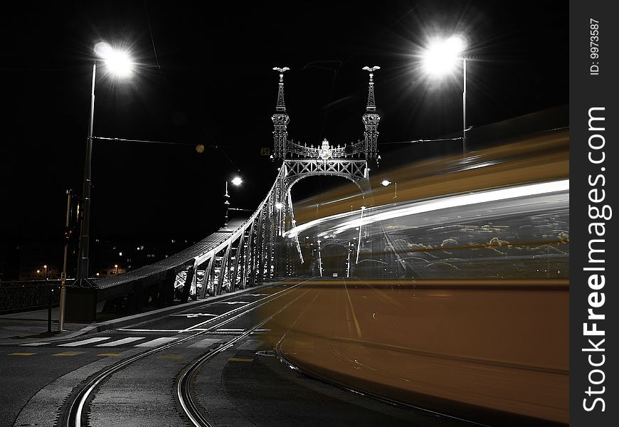 Tram turning on to a bridge at night