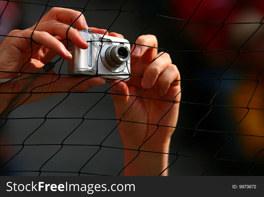 A person taking a picture with a digital camera. A person taking a picture with a digital camera