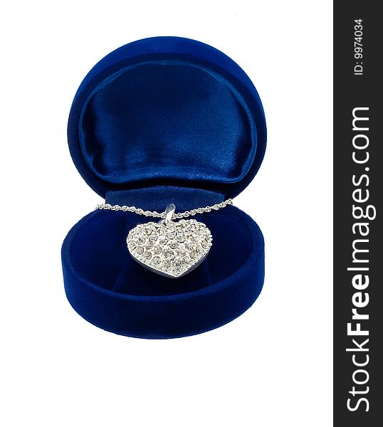 Chain with a brooch in form of heart in blue present box on white background. Chain with a brooch in form of heart in blue present box on white background