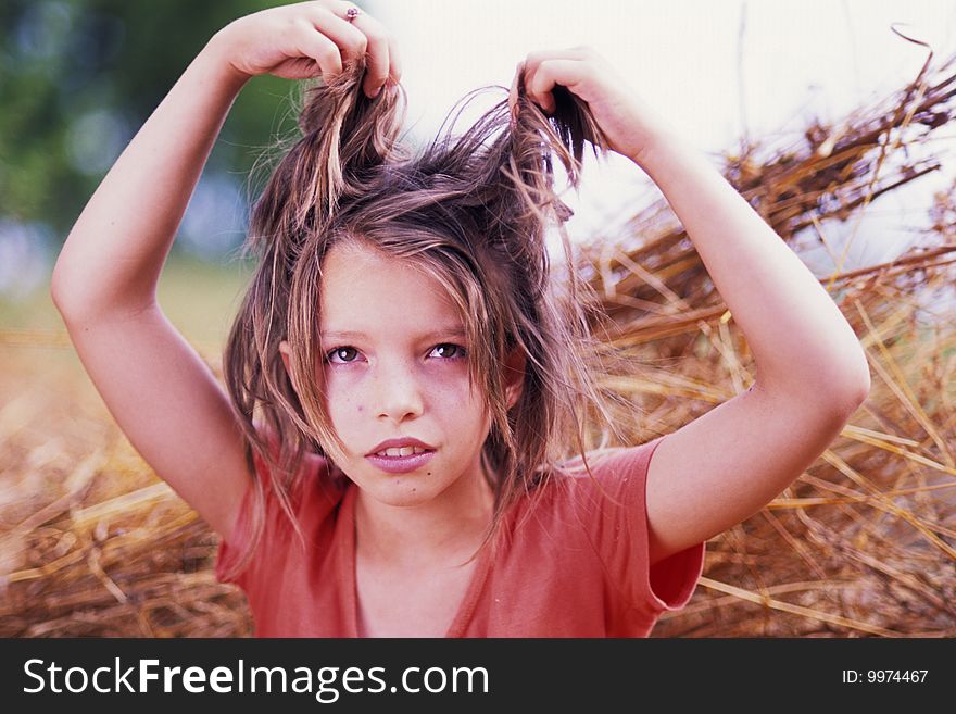 Portrait of beautiful girl with hands in hair in nature. Portrait of beautiful girl with hands in hair in nature