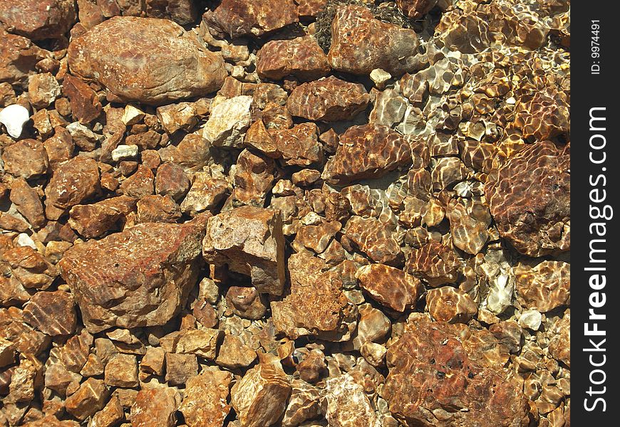 Some rocks underwater in a mountain stream. Some rocks underwater in a mountain stream.