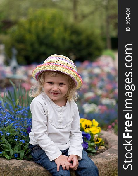 The little girl in a hat on the nature. The little girl in a hat on the nature