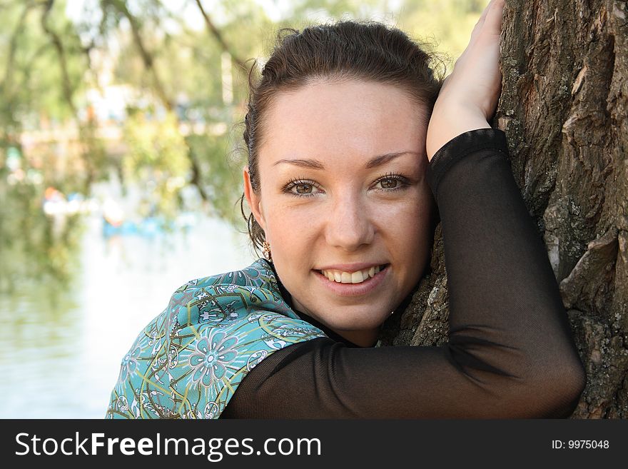 Beautiful woman near tree in the park