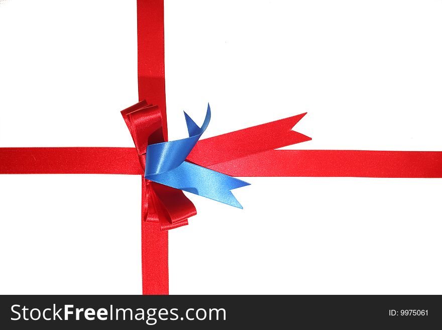 Red ribbon dressed like a present on a withe isolated background with copy space. Red ribbon dressed like a present on a withe isolated background with copy space