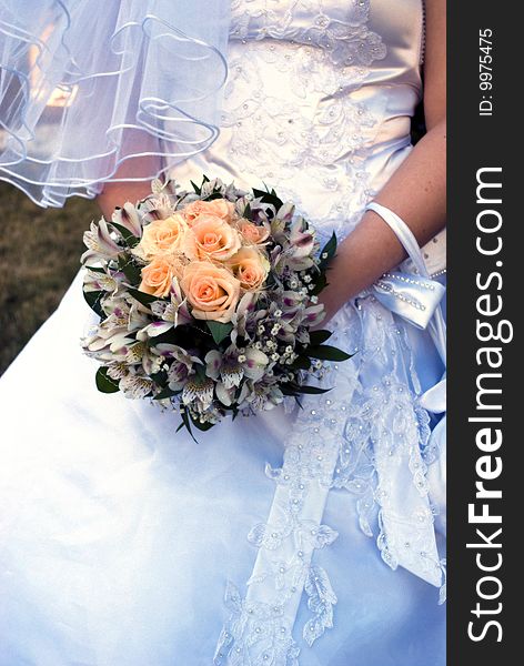 Wedding bouquet with roses in bride's hands