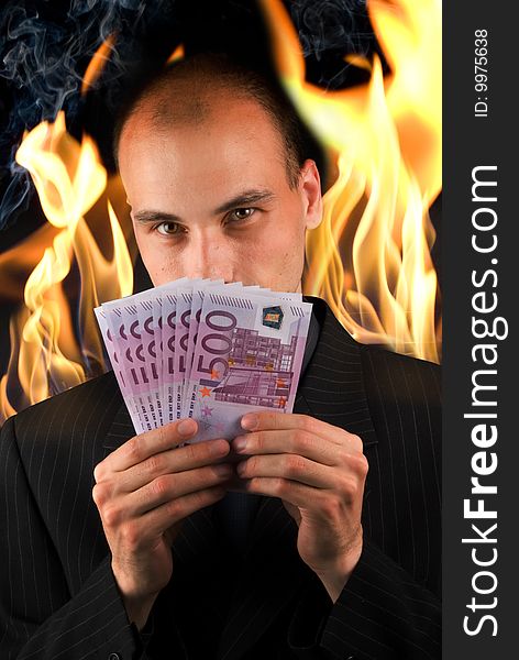 Businessman holding money in hell