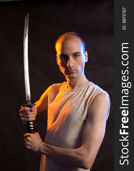 Male with Katana. Dark background