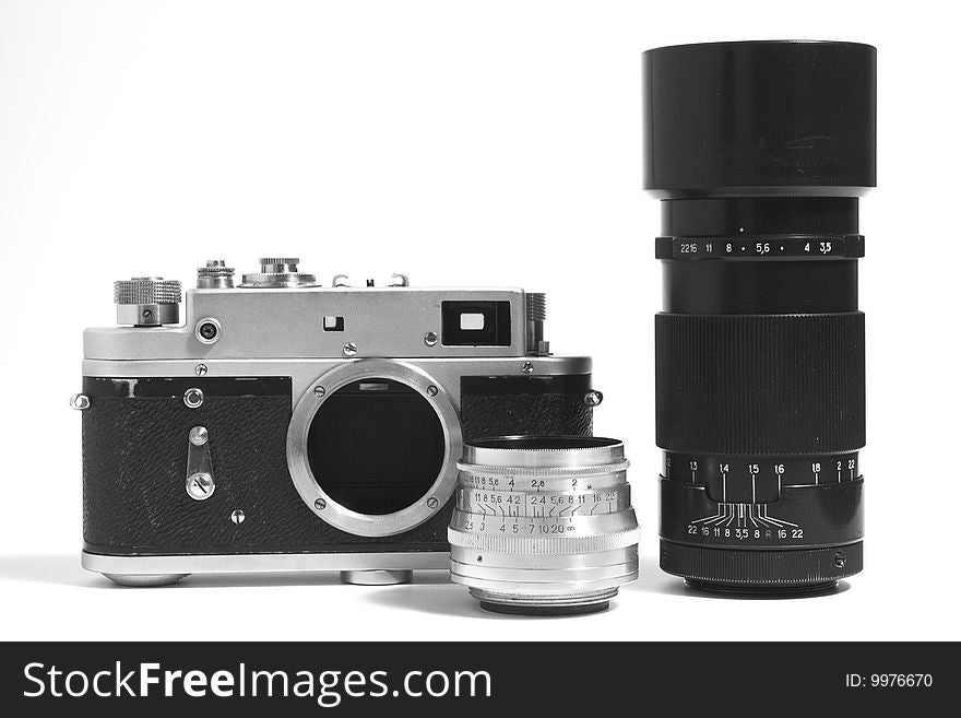 A classic manual film camera and objective, on white. A classic manual film camera and objective, on white.