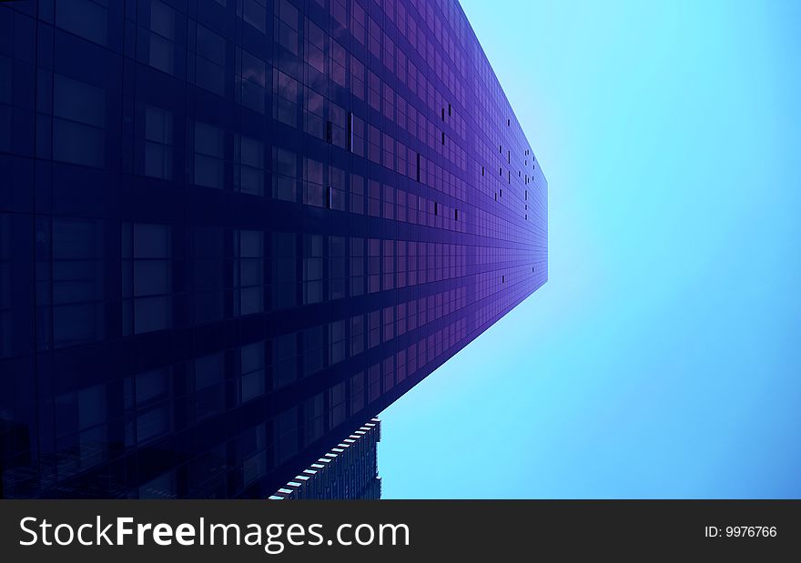 Modern skyscraper close-up toned in blue color