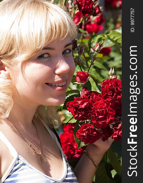 Beautiful woman with roses in park