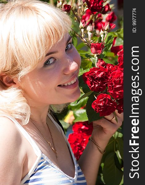 Beautiful woman with roses in park