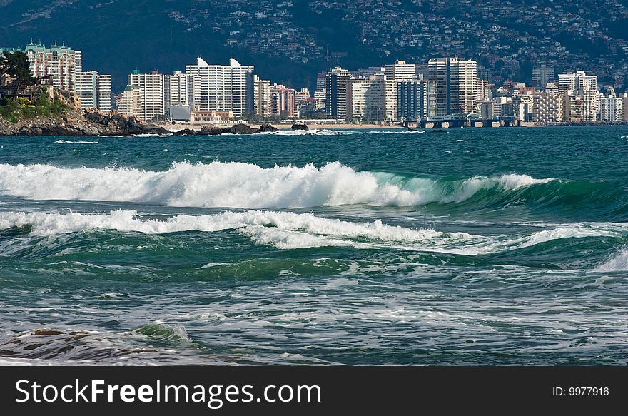 Beach scenes with a cityscape background, Chile.