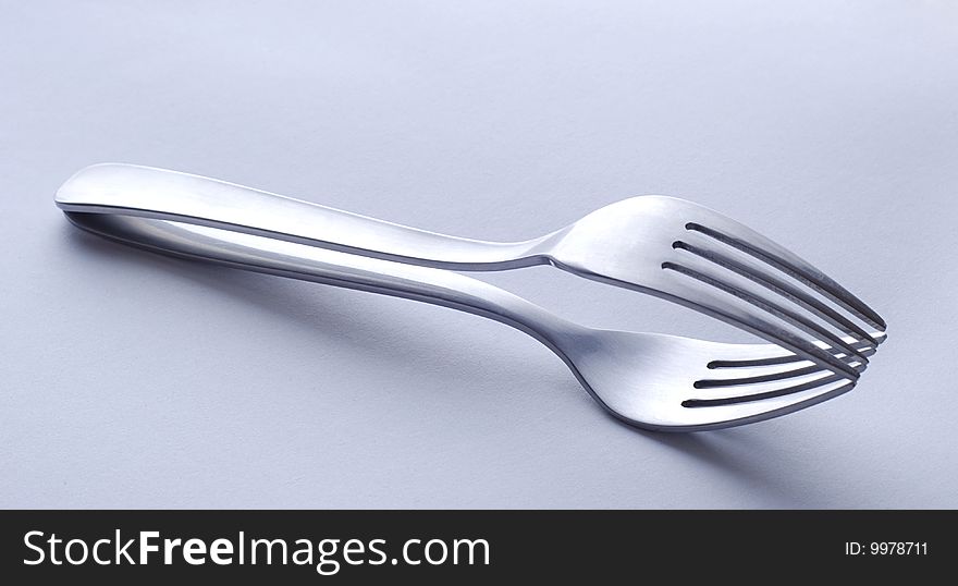 Metal shiny forks laying one over another. Metal shiny forks laying one over another