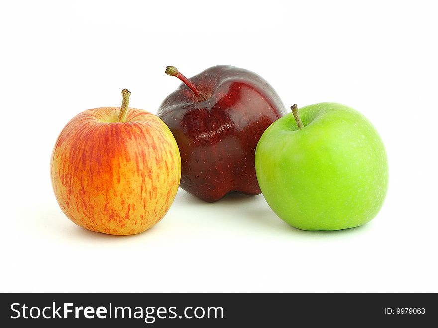 Three apples in different colour isolated on white