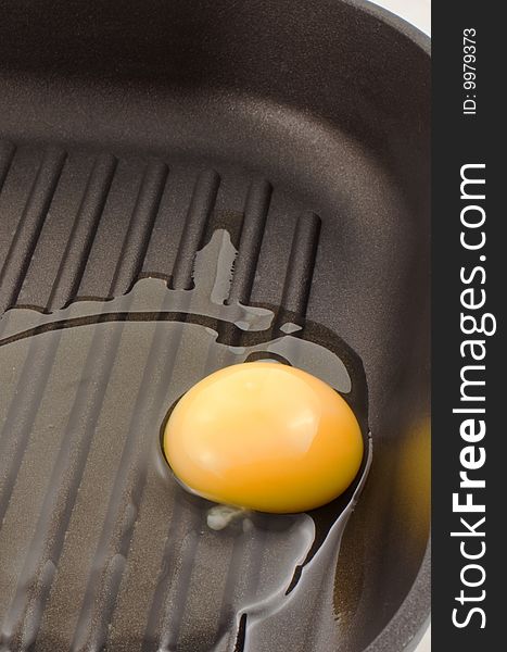 Broken Egg On A Black Frying Pan