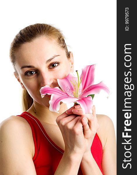 A portrait of a nice blond girl in red with a pink lily near her face on a white background. A portrait of a nice blond girl in red with a pink lily near her face on a white background